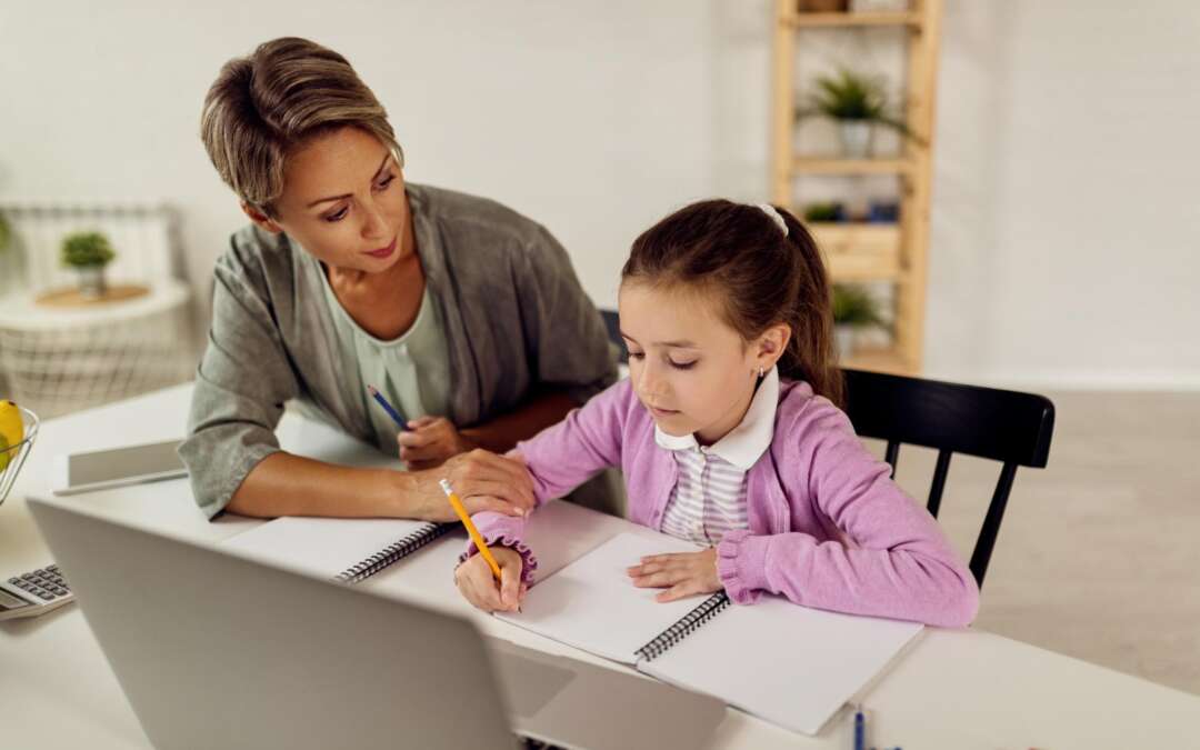 girl studying at home with mom